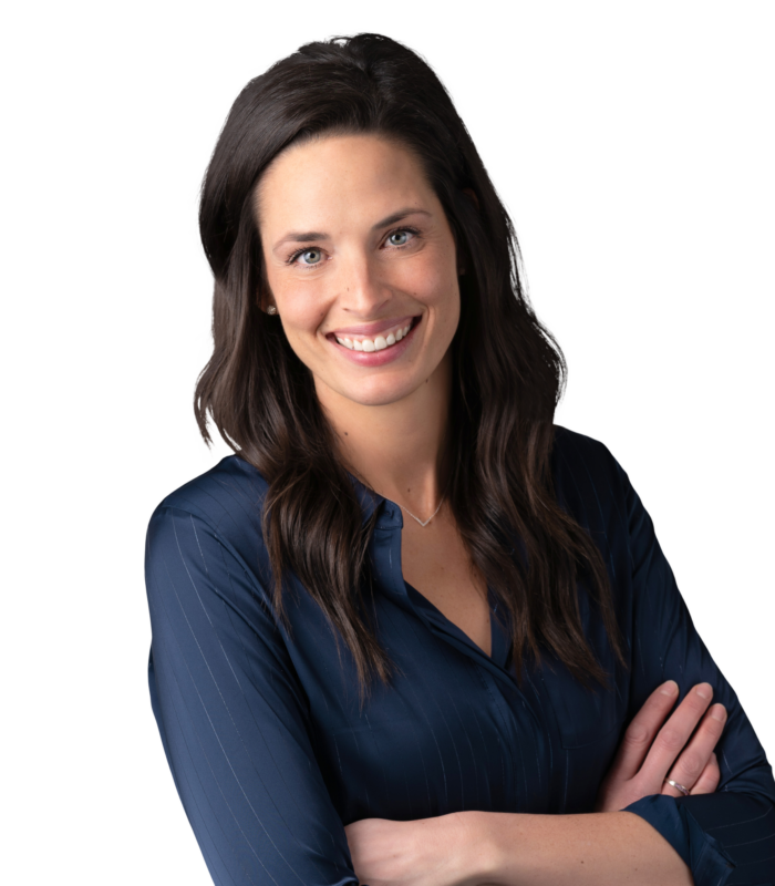 Meet Our Team - Professional and Welcoming Group at a Conference Table Faces the Camera, Team Leader Sitting on the Table with Arms Folded